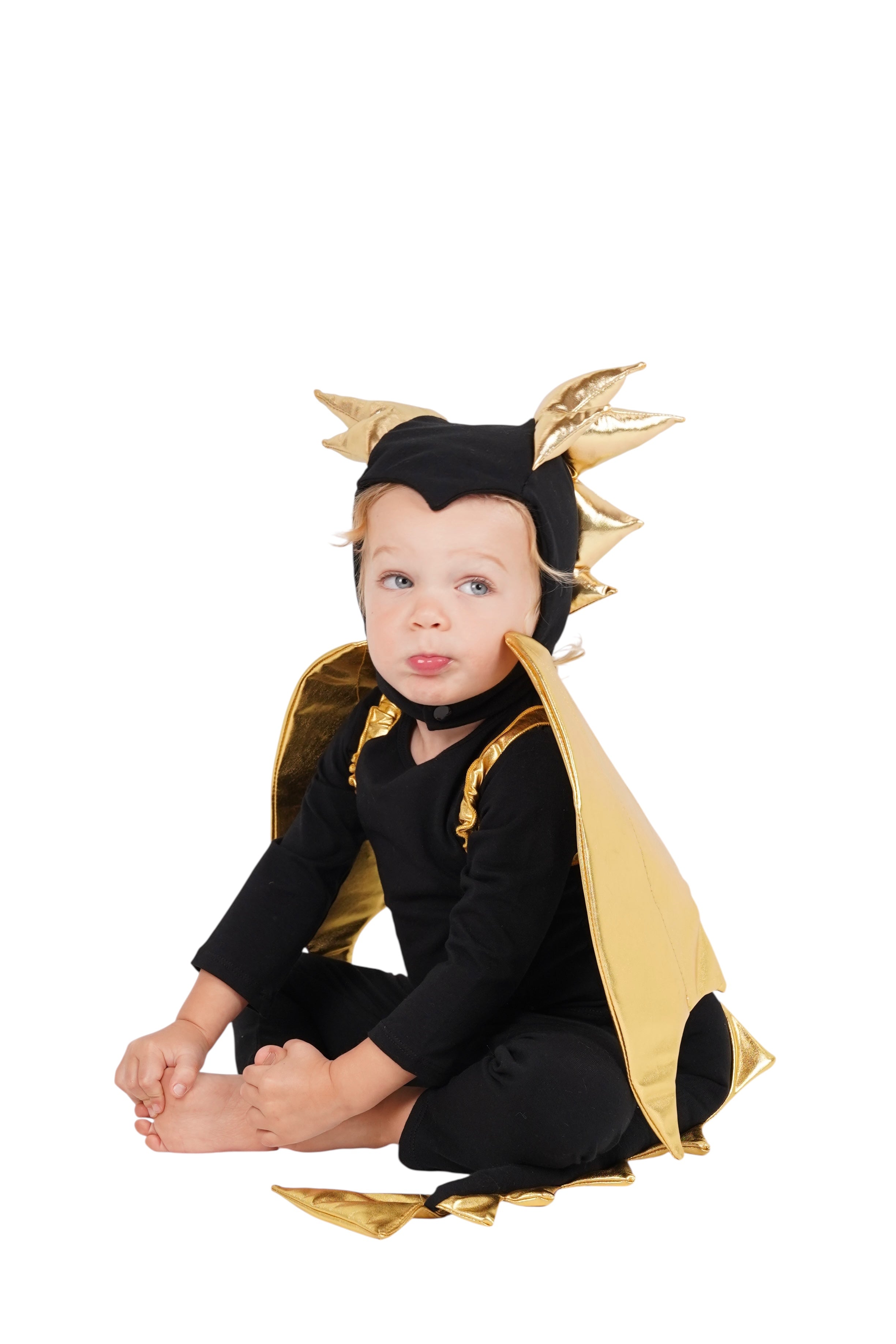 Child wearing a black and gold dragon costume on a white background