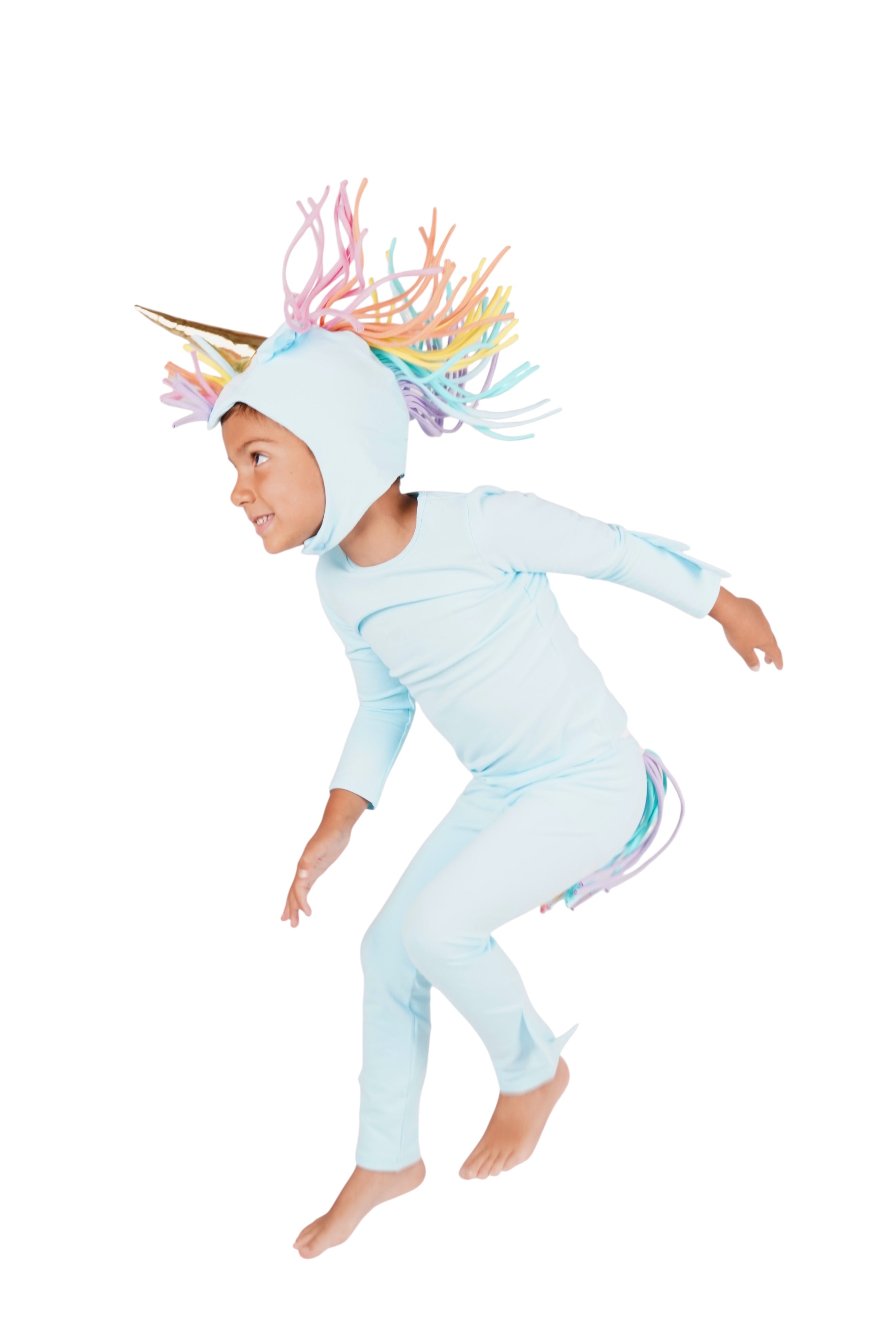 Child wearing a light blue unicorn costume with colorful horn on a white background