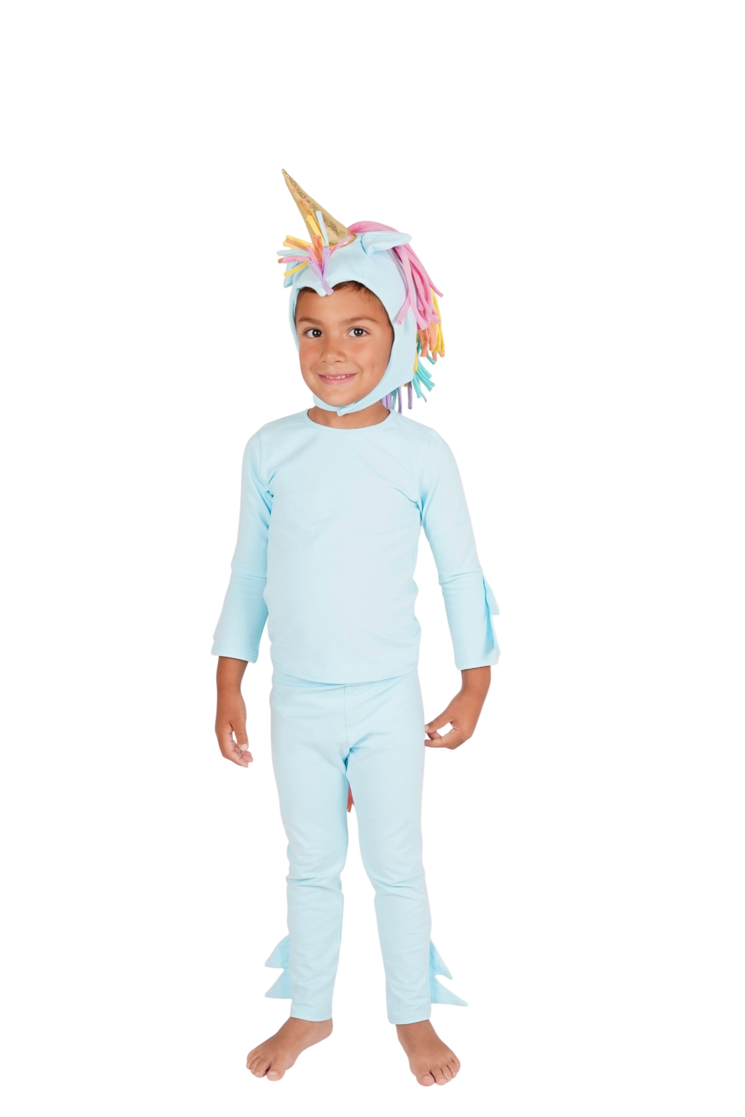 Child wearing a light blue unicorn onesie with a hood on a white background