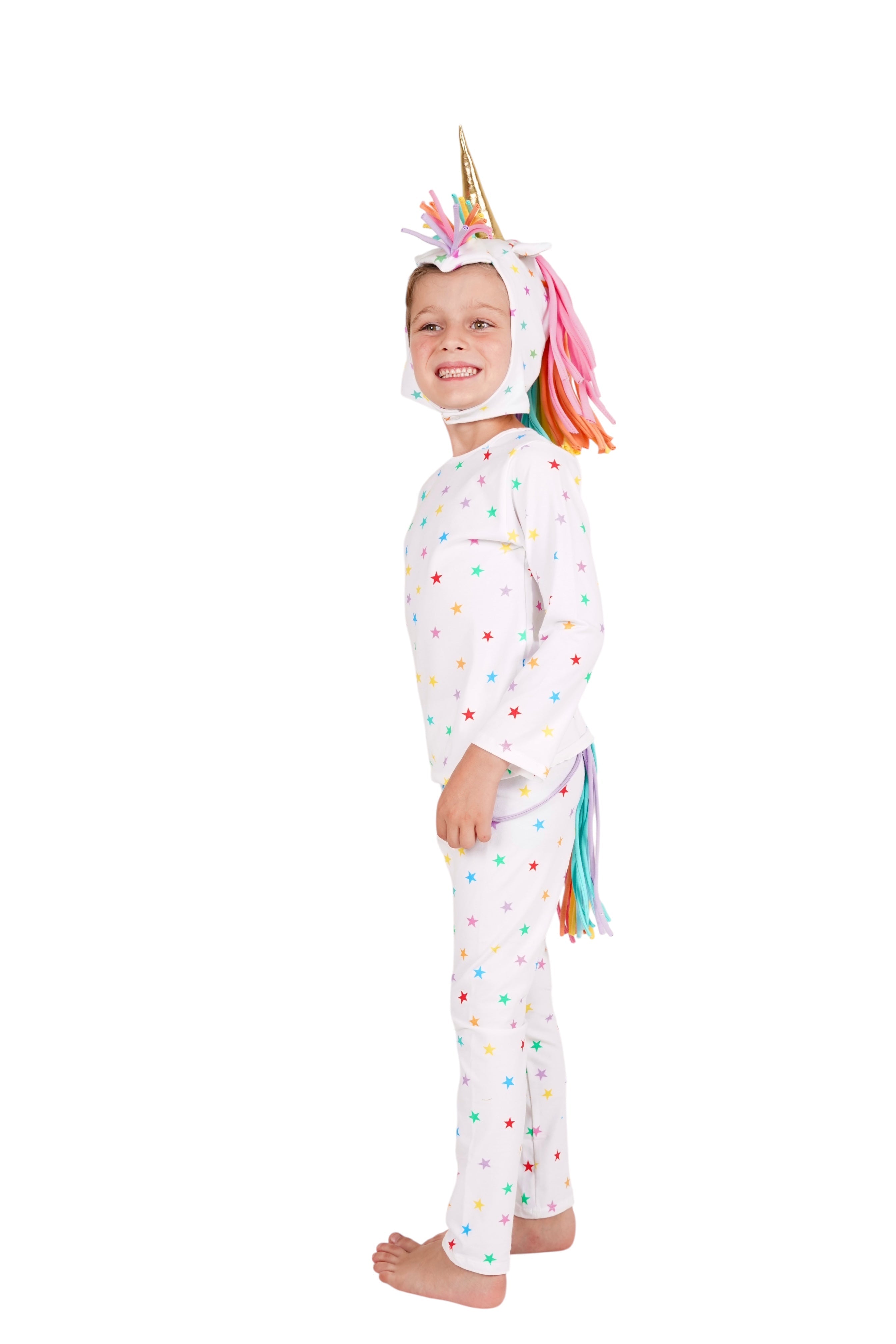 Child wearing a unicorn onesie with a colorful mane and tail on a white background