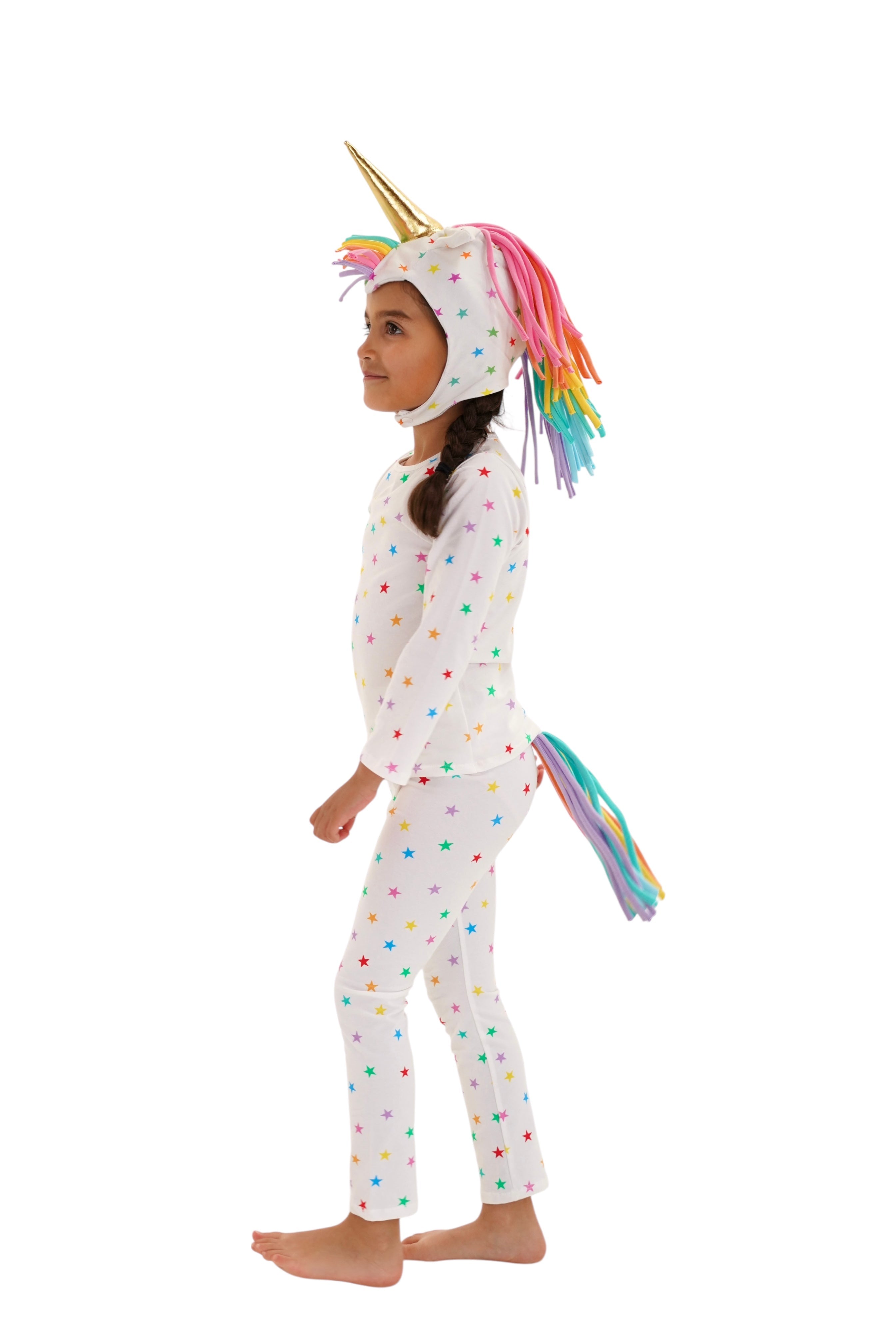 Child wearing a unicorn onesie with colorful polka dots on a white background