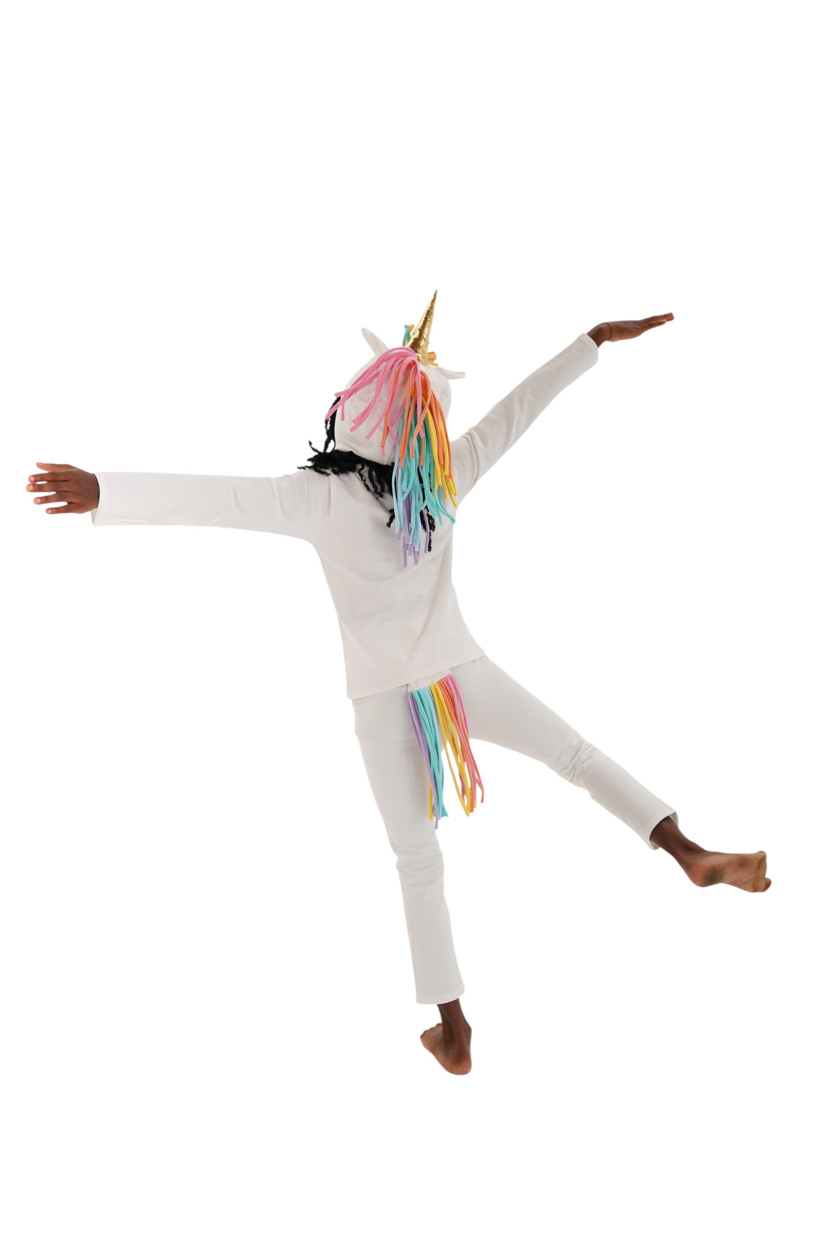 Person wearing a unicorn onesie with rainbow accents on a white background