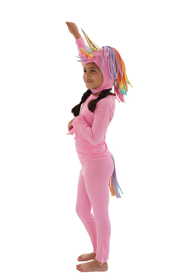 Child wearing a pink unicorn onesie with a rainbow mane on a white background