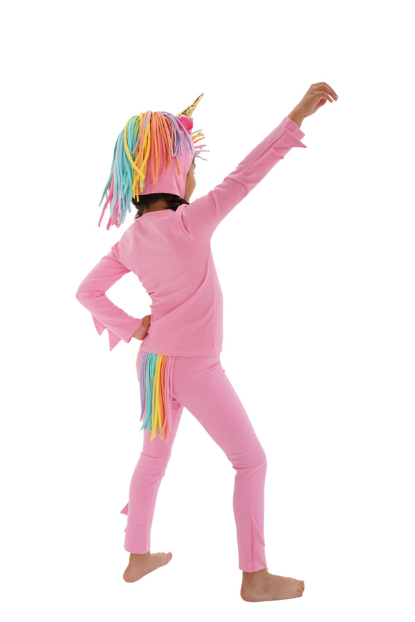 Child wearing a pink unicorn costume with rainbow hair and tail on a white background