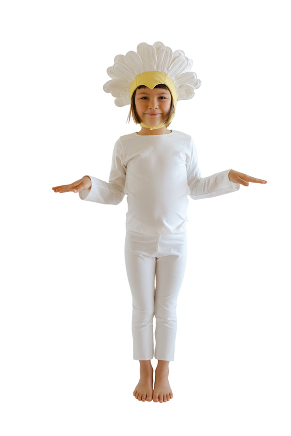 Child wearing a white flower costume with a yellow center on a white background