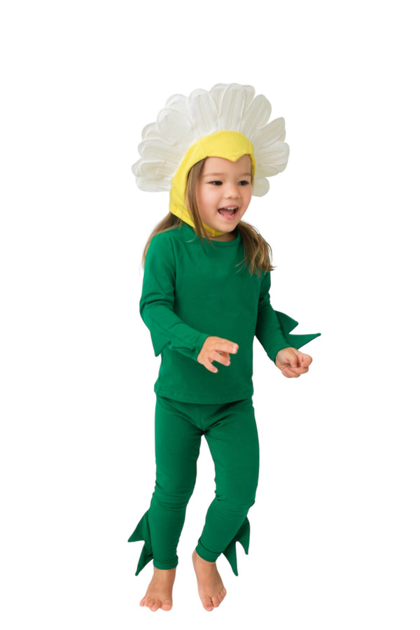 Child wearing a green plant costume with a white flower head on a white background