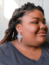 Close-up of pink and silver rustic ladder earrings handcrafted by Fair Anita artisans in India