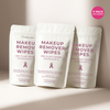 Three packs of Freedom Makeup Remover Wipes with a pink ribbon on a beige background