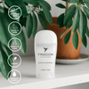 Freedom natural deodorant bottle with green leaves in the background