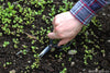 Forged steel pruning shears in use, demonstrating multi-purpose garden and kitchen cutting