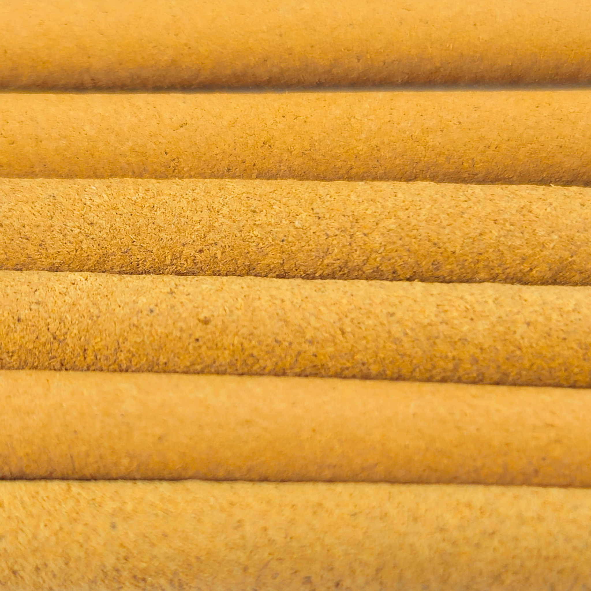 Close-up of yellow cylindrical objects with a textured surface