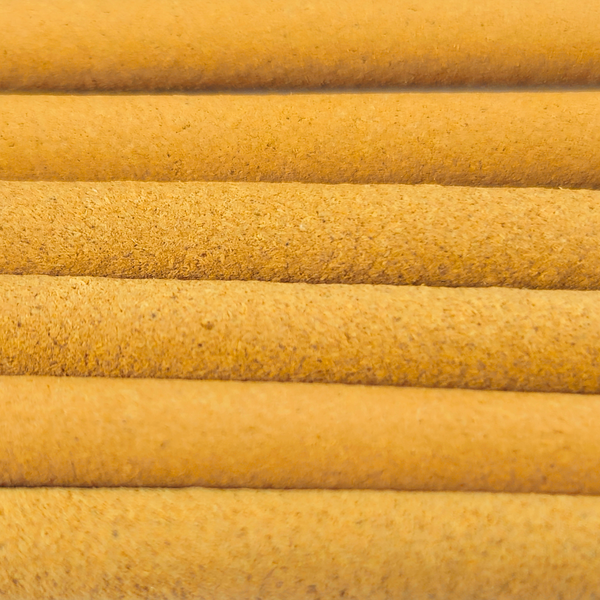 Close-up of yellow cylindrical objects with a textured surface