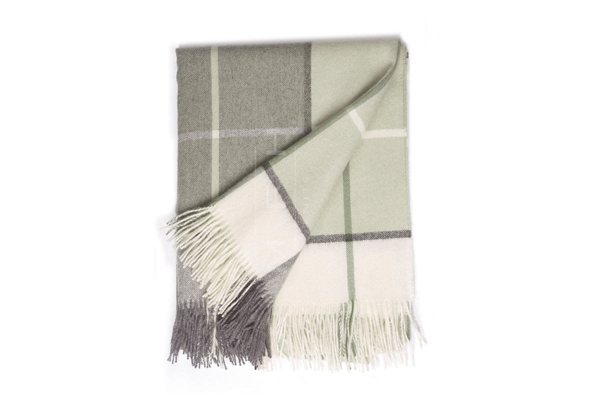 Plaid blanket with fringes on a white background
