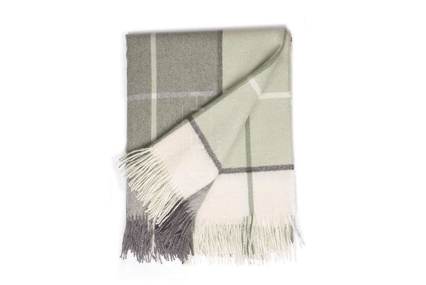 Plaid blanket with fringes on a white background
