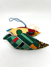 Two handmade African wax print patchwork ornaments showing varied fabric patterns front and back