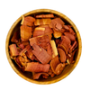Wooden bowl filled with reddish-brown wood chips on a white background