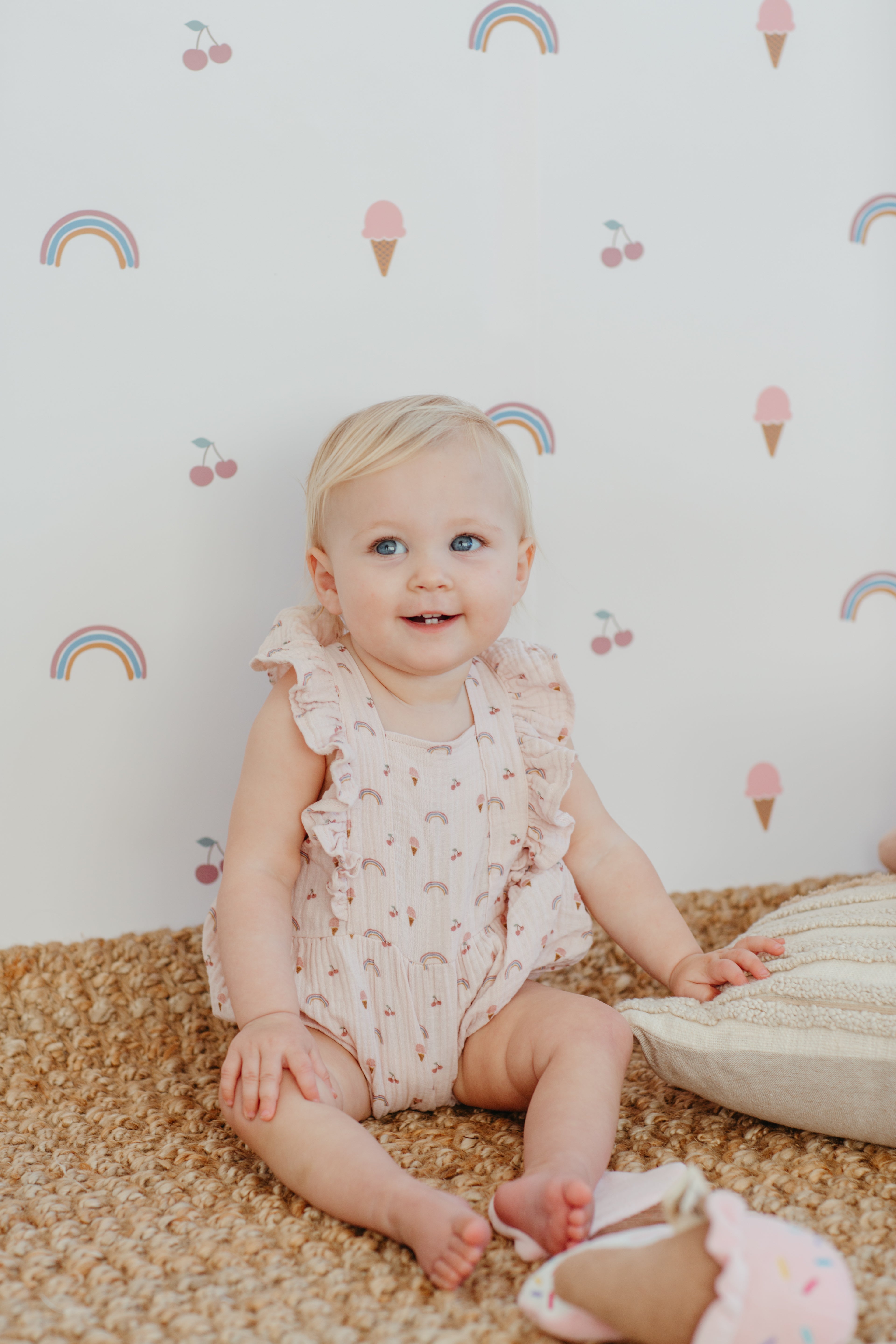 Rainbows and ice cream print organic cotton muslin flutter sleeve baby romper laid flat