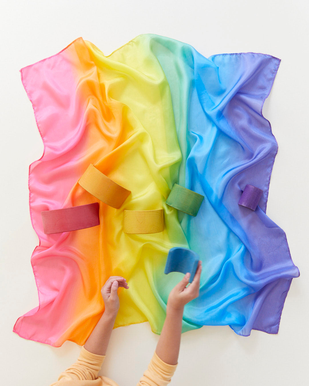 Child playing with Sarah's Silks Rainbow Playsilk, natural silk open-ended toy in rainbow colours