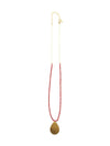 Detail shot of red glass beads and brass pendant necklace by Fair Anita
