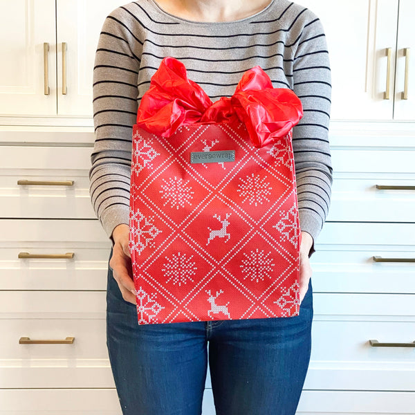 EverBag medium reusable eco-friendly gift bag with knitted sweater motif displayed alongside wrapped gifts
