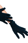 Black gloves being worn on a white background
