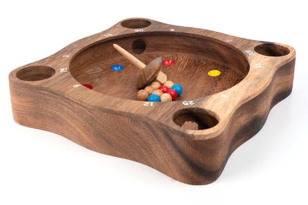Wooden game board with darts and colored markers on a white background