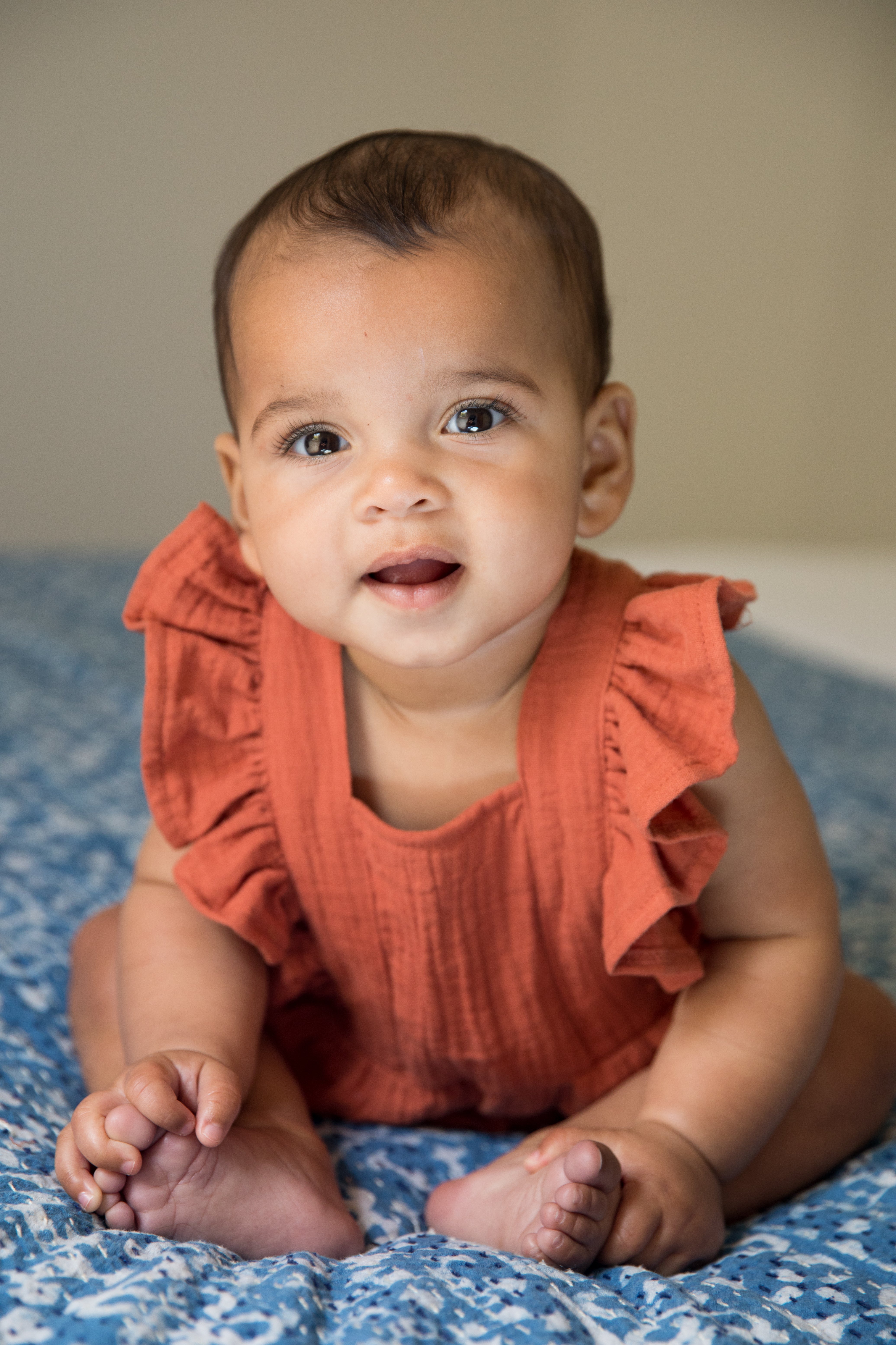 Rust organic muslin flutter sleeve romper for babies — front and back view