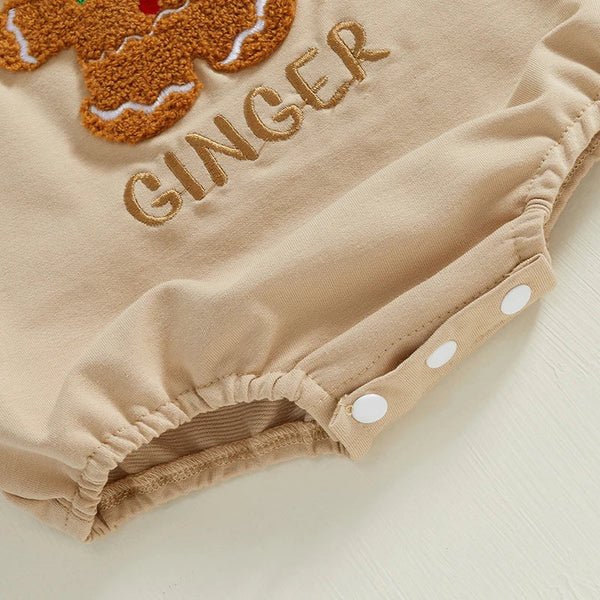 Beige baby romper with gingerbread design and 'GINGER' text on a light background