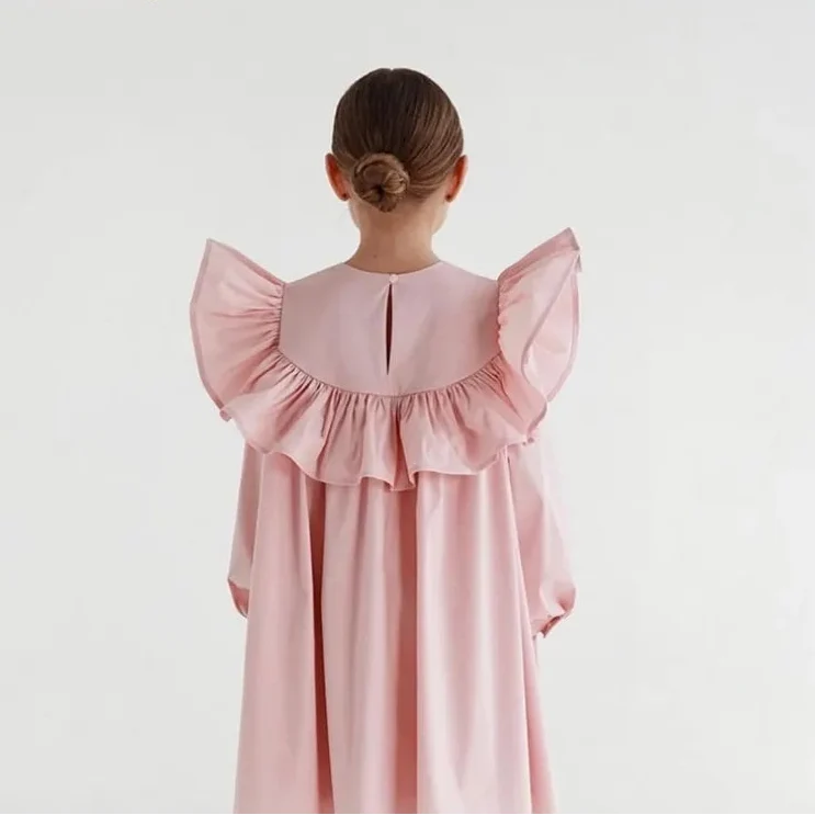 Child wearing the Flying Sleeve Ruffle Dress with ruffle sleeve detail