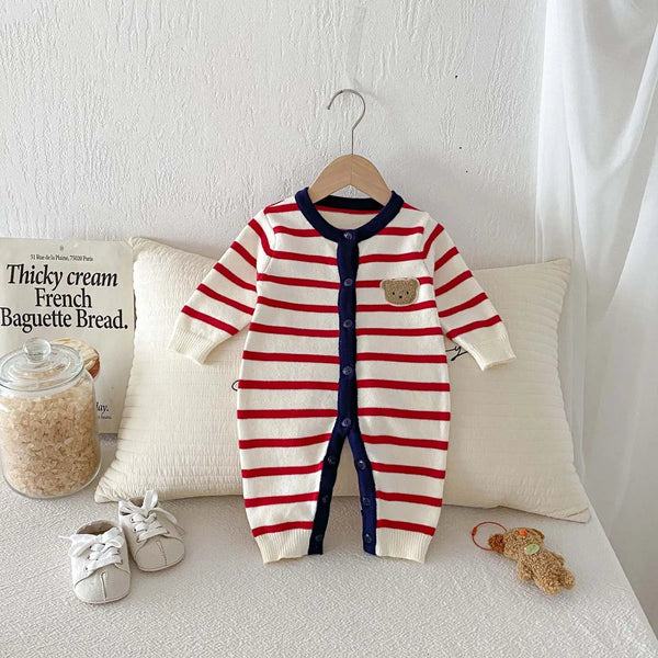 Close-up of the striped knit fabric and bear detail on the jumpsuit