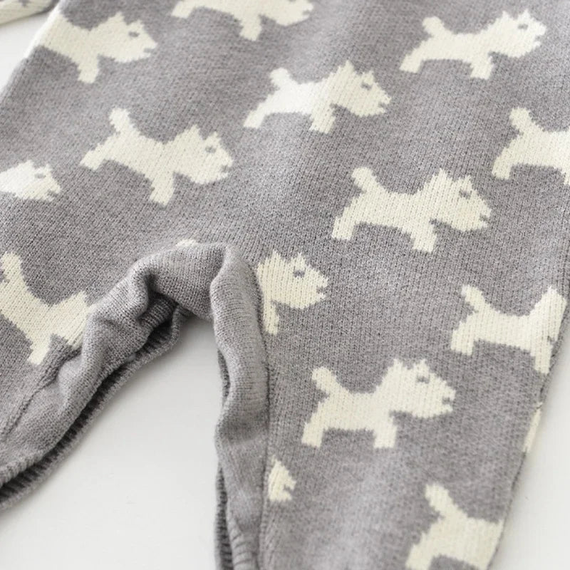 Gray blanket with white dog pattern on a white surface
