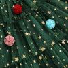 Green fabric with gold star patterns and colorful pom-poms.