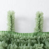 Green ruffled top on a white background