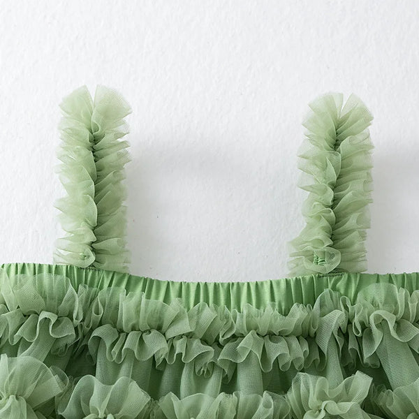 Green ruffled top on a white background