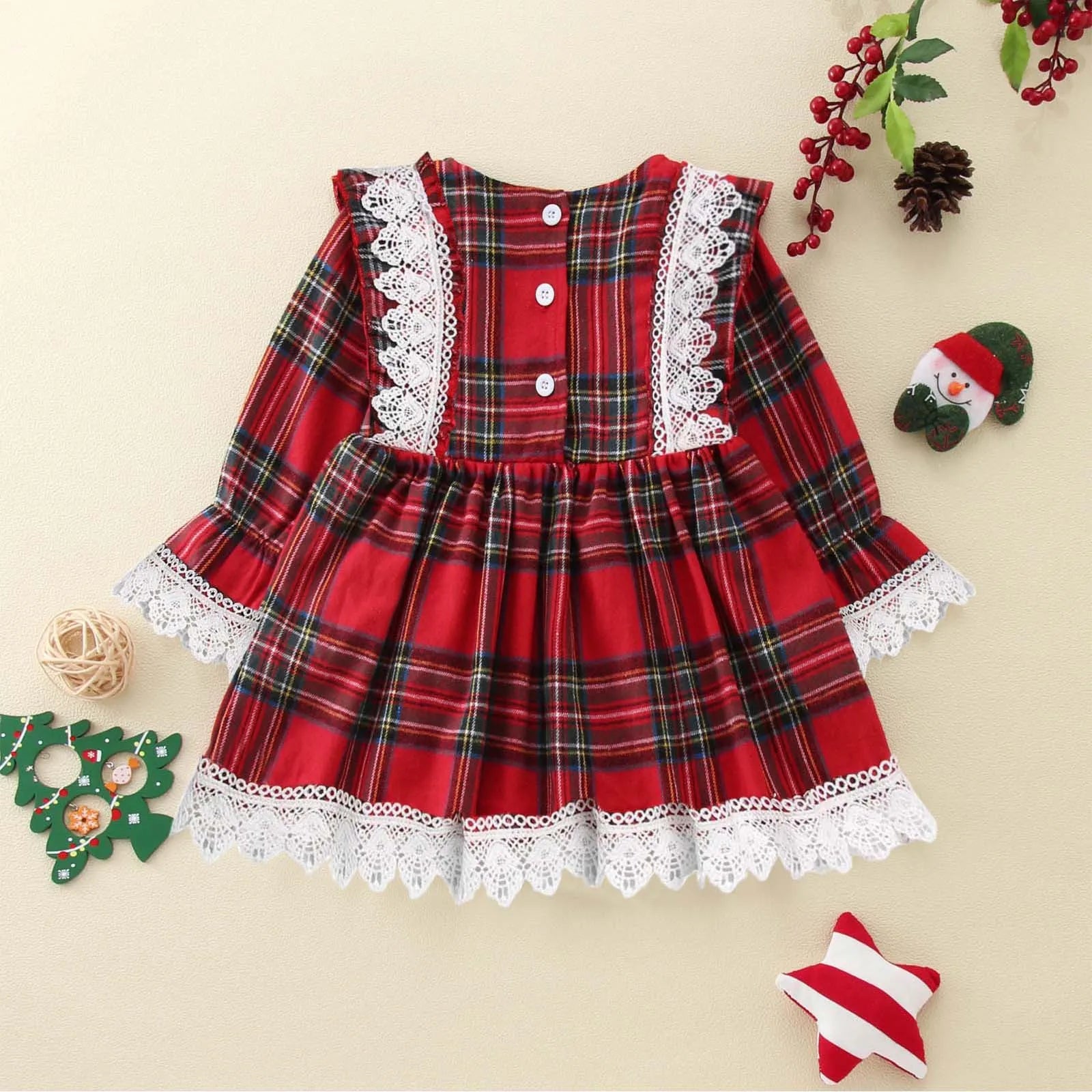 Baby wearing the Plaid Christmas Flare Dress by Ryan and Remi