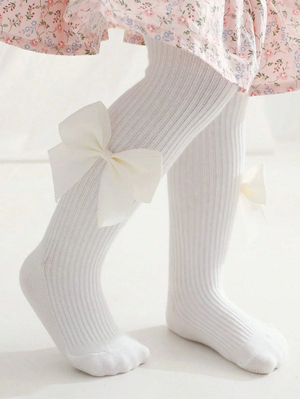 Close-up of side bowknot detail on knit leggings