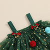 Green dress with red bows and pom-poms on a beige background