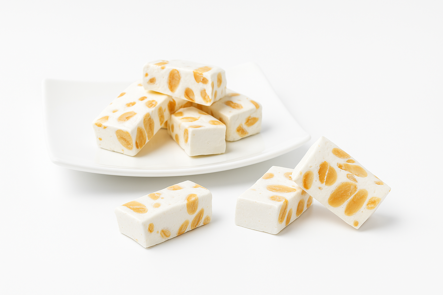 Close-up of sugar-free almond brittle nougat pieces showing whole roasted almonds embedded in crystalline brittle