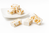 Andy Anand gluten-free almond nougat brittle pieces arranged on a surface, highlighting crunchy texture and whole almonds