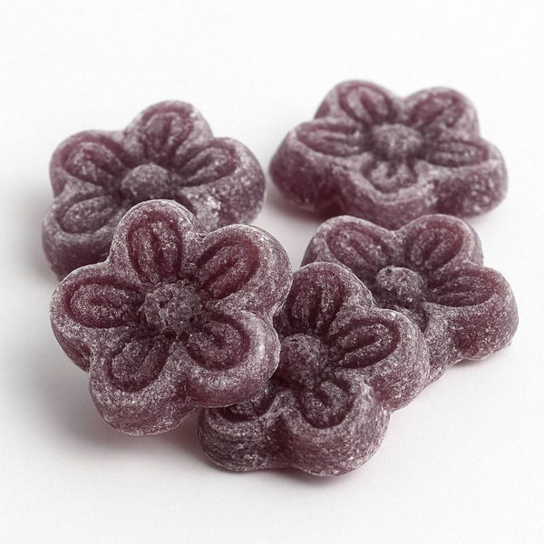 Purple flower-shaped candies on a white background