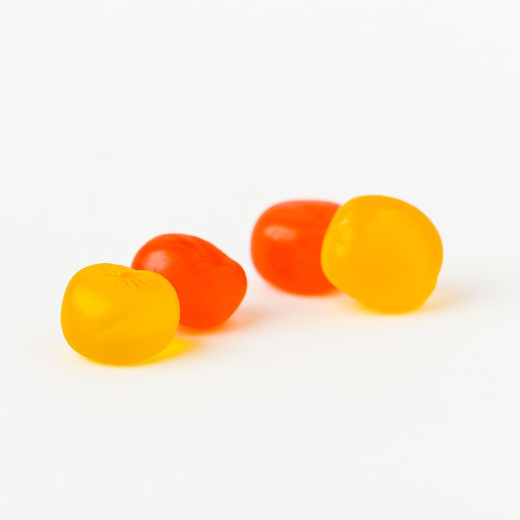 Assorted strawberry, mango and peach vitamin C gummies arranged on a surface