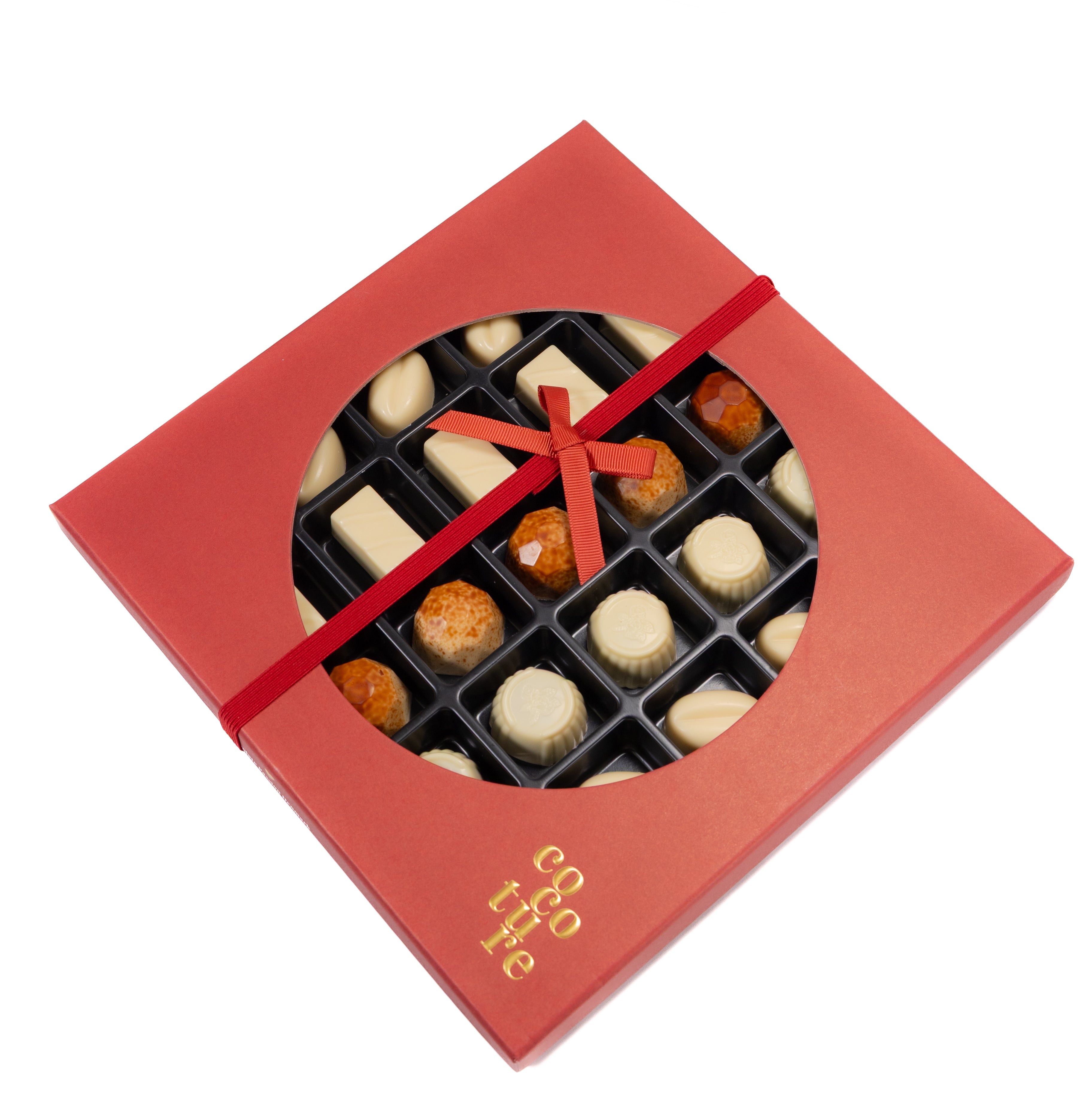 Close-up of Andy Anand sugar free white chocolate truffle pralines with smooth creamy texture
