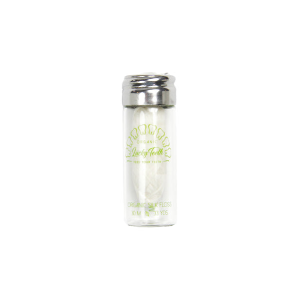 Clear glass tumbler with silver lid on a white background