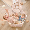 Child playing with Tiny Land 200-piece non-toxic ball pit balls in a toddler ball pit
