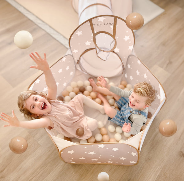 Child playing with Tiny Land 200-piece non-toxic ball pit balls in a toddler ball pit