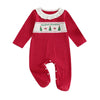 Close-up of the polka dot and Christmas tree print on the organic cotton romper