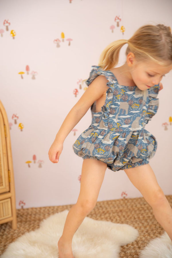 Close-up of Safari Party organic cotton muslin flutter sleeve romper showing print detail and snap closure