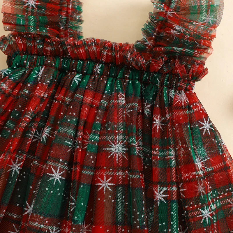 Red and green plaid dress with white star patterns on a beige background
