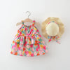 A toddler girl's sleeveless tiered dress with a colorful floral tulip print, displayed on a wooden hanger next to a matching straw sun hat with a ribbon bow, against a clean white background.