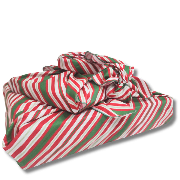 Red, green, and white striped fabric wraps on a white background